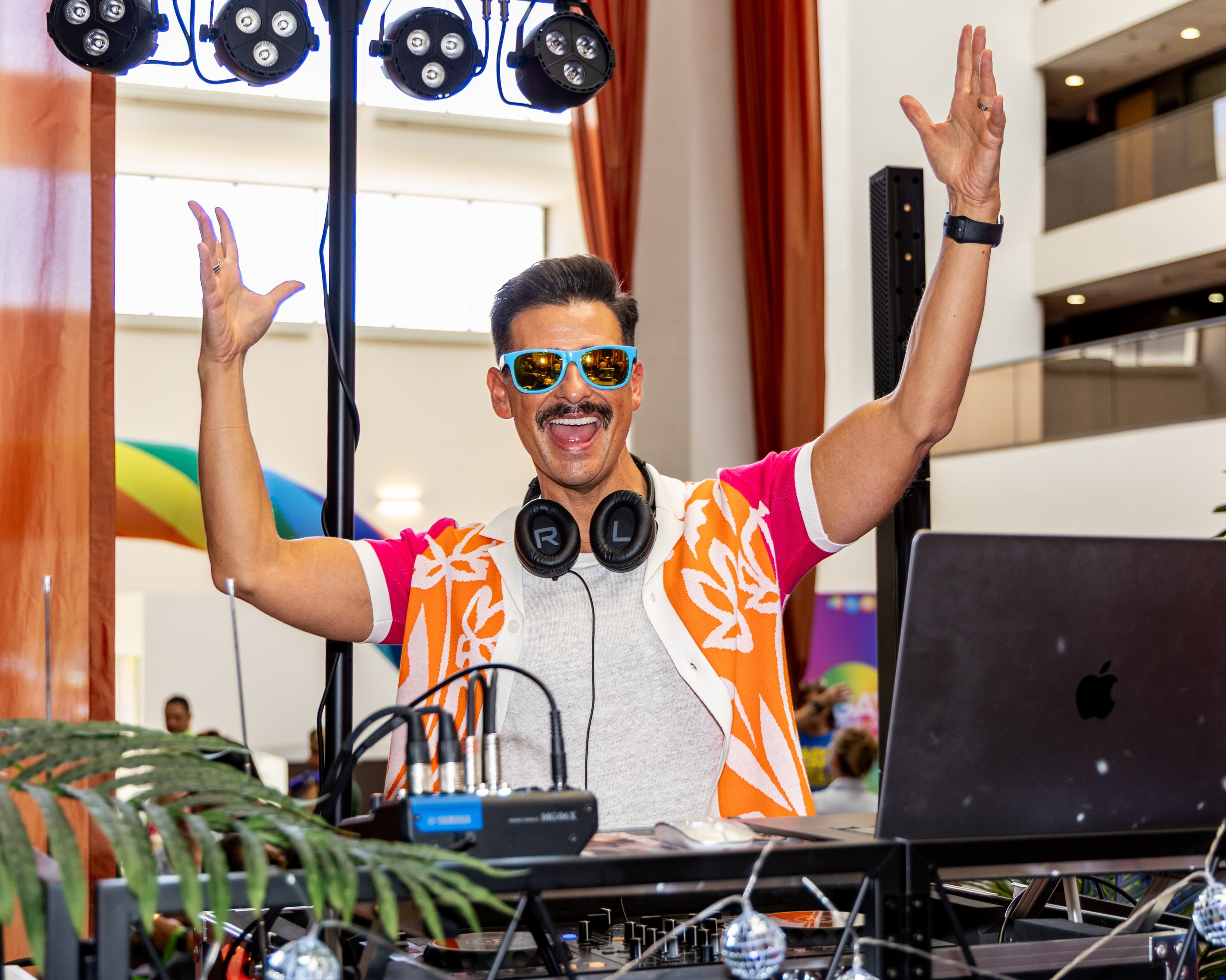 DJ DISCOBOY at the decks with arms raised