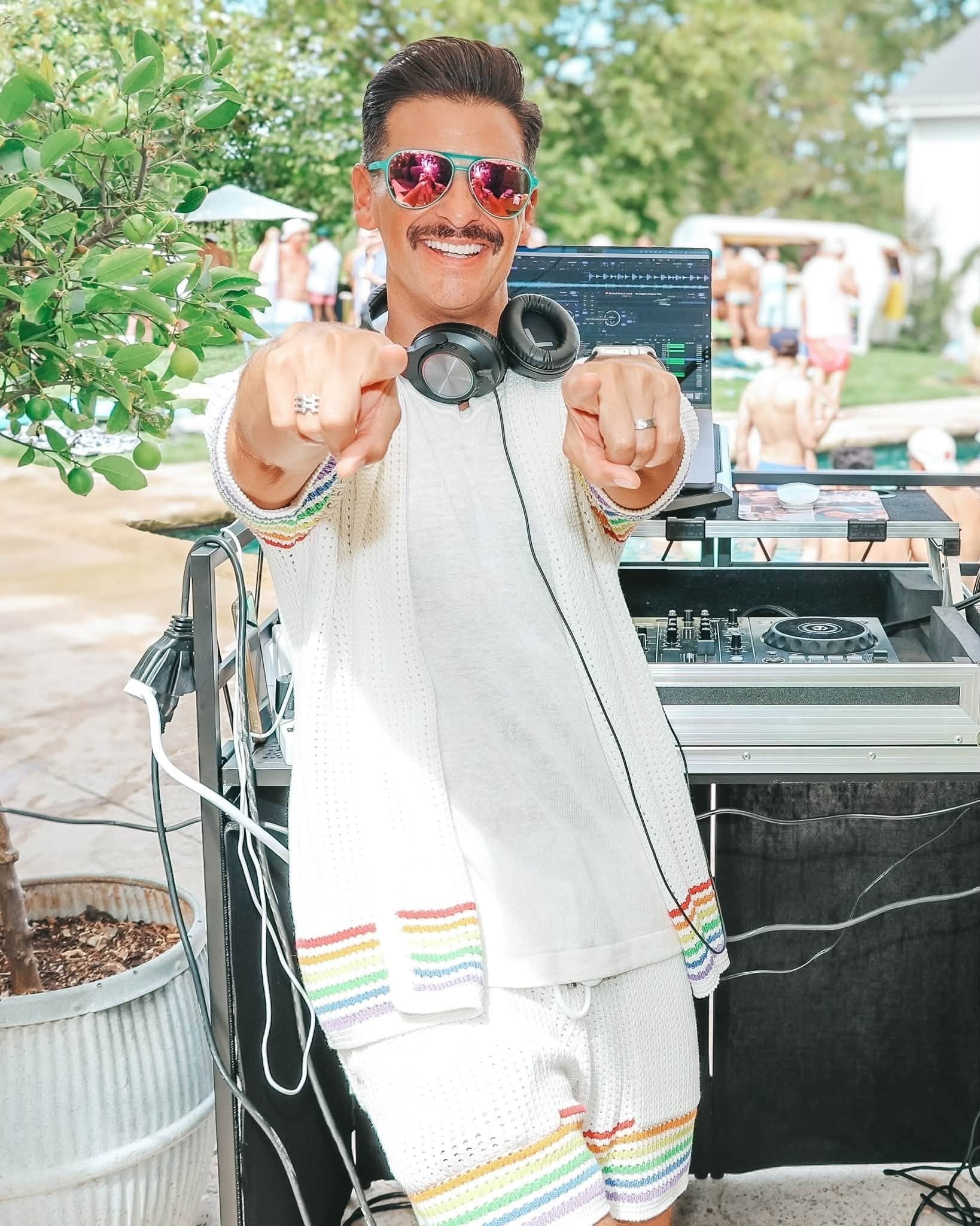 DJ DISCOBOY pointing at camera outdoor pool party
